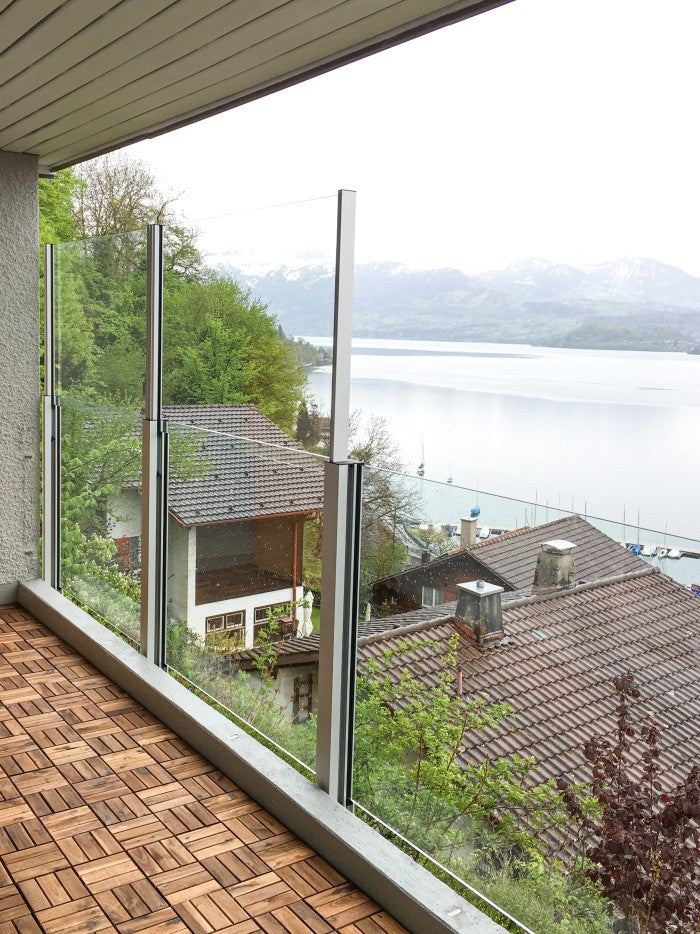 SlideGlass® auf der Terrasse über dem See, Windschutz hochgestellt